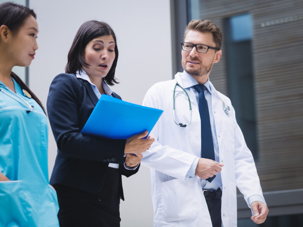 doctors and nurse interacting while walking in hospital premises