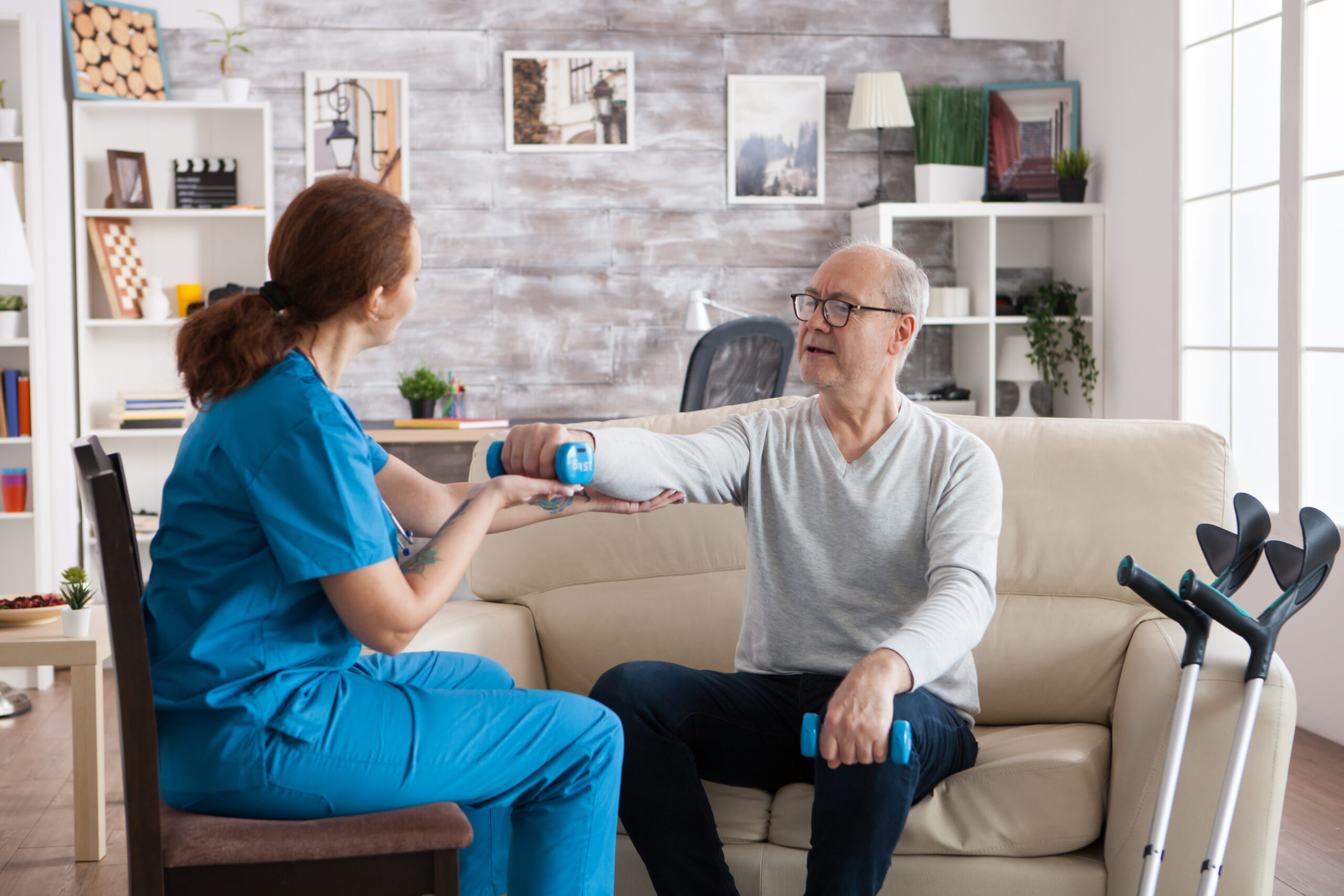 young nurse doing physiotherapy treatment in nursing home